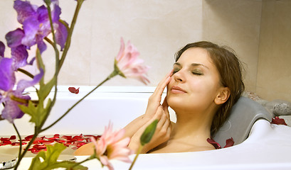 Image showing woman in a bath with rose-petals