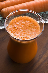 Image showing carrot juice on a wooden background 