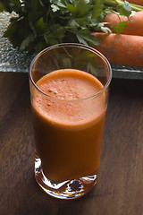 Image showing carrot juice on a wooden background 