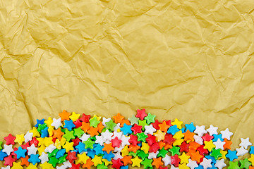 Image showing Multicolored stars on a background of crumpled paper