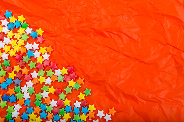 Image showing Multicolored stars on a background of crumpled paper