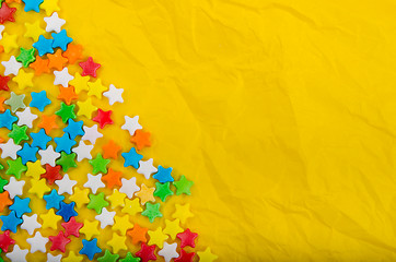 Image showing Multicolored stars on a background of crumpled paper