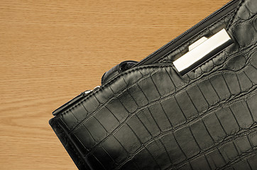 Image showing A black business bag on a wooden background