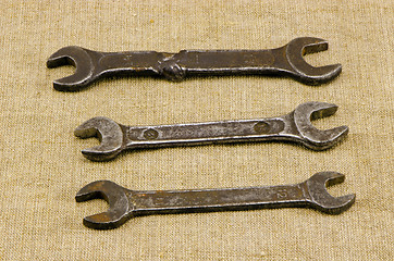 Image showing three retro screw spanners wrench tools on linen 