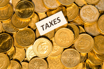 Image showing Taxes sign on golden coins