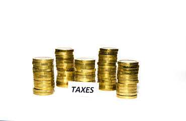 Image showing Taxes sign at coin piles