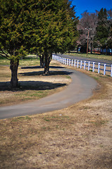 Image showing country sidewalk with white fence