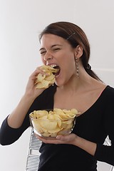 Image showing Woman eating chips