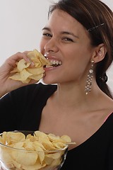 Image showing Woman eating chips