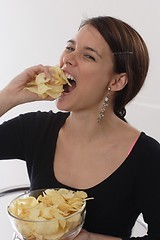 Image showing Woman eating chips