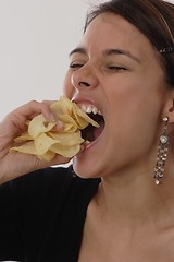 Image showing Woman eating chips