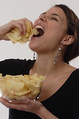 Image showing Woman eating chips