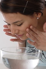 Image showing Woman cleaning face