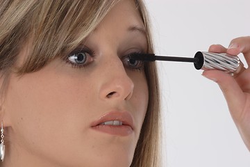 Image showing Woman applying eyelash makeup