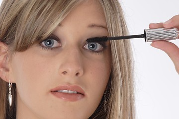 Image showing Woman applying eyelash makeup