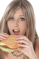 Image showing Woman eating burger