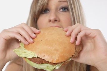 Image showing Woman eating burger