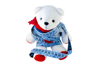 Image showing small Teddy with red feet wrapped blue centimeter  