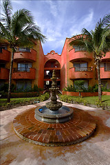 Image showing fountain and red house 