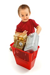 Image showing Little boy throwing presents in garbage bin