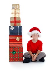 Image showing Child sitting near presents