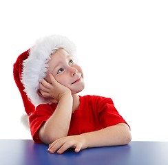 Image showing Boy in Santa hat, looking to copy space