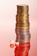 Image showing Pills standig beside pile of coins