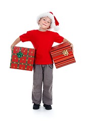 Image showing Young boy holding Christmas gifts