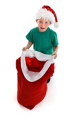 Image showing Happy little boy holding open Santa sack