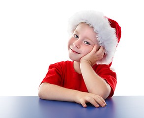 Image showing Cute Christmas boy sitting at table