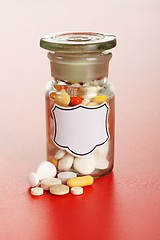 Image showing Chemical bottle with colorful pills