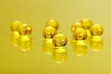 Image showing Macro of E vitamine capsules on yellow