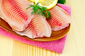 Image showing Fillets tilapia in a pottery on a napkin