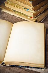 Image showing open old book on a wooden surface 