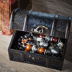 Image showing  casket with jewelry and old book on a wooden surface 