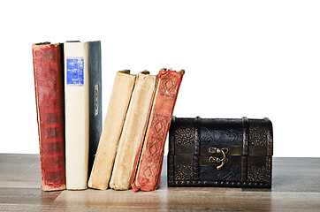 Image showing  casket and old book on a wooden surface 