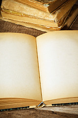 Image showing open old book on a wooden surface 