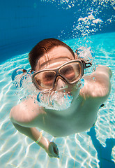 Image showing teenager floats in pool