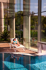 Image showing girl on a sun lounger