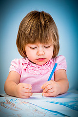 Image showing Little baby girl draws pencil