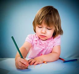 Image showing Little baby girl draws pencil