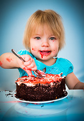 Image showing Little baby girl eating cake