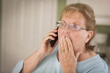 Image showing Shocked Senior Adult Woman on Cell Phone in Kitchen