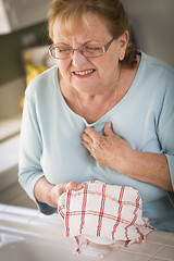 Image showing Senior Adult Woman At Sink With Chest Pains