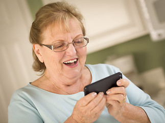 Image showing Senior Adult Woman Texting on Smart Cell Phone