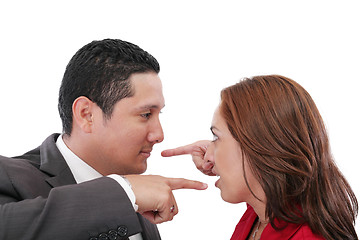 Image showing Young couple pointing at each other against a white background 