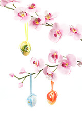 Image showing hanged bright color easter eggs with bows on spring flower