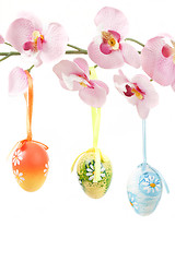 Image showing hanged bright color easter eggs with bows on spring flower