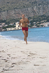 Image showing Man Running Along Beach