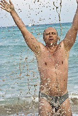 Image showing Portrait of man with spashes in the sea